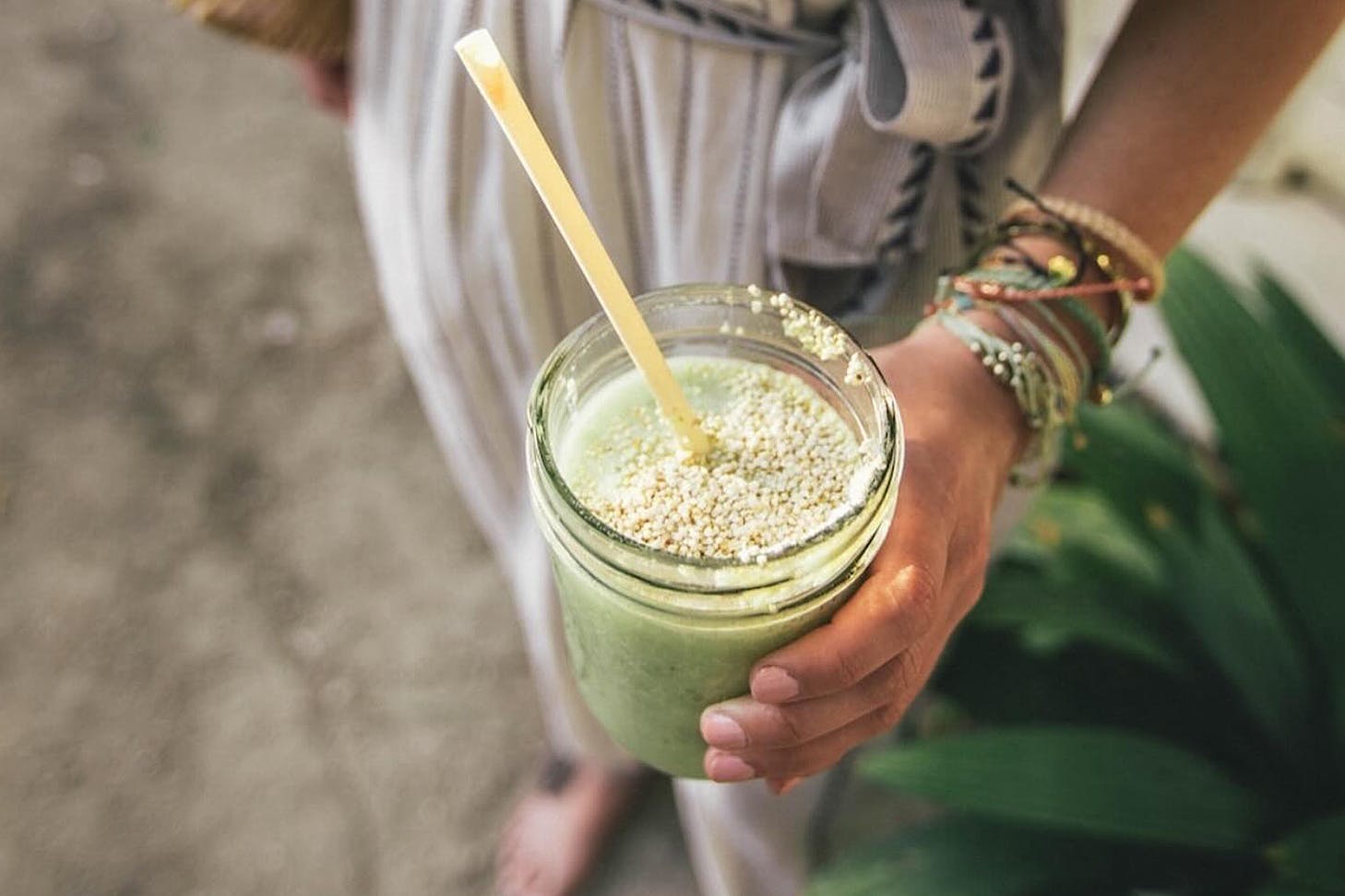 Someone holds a cleansing smoothie.